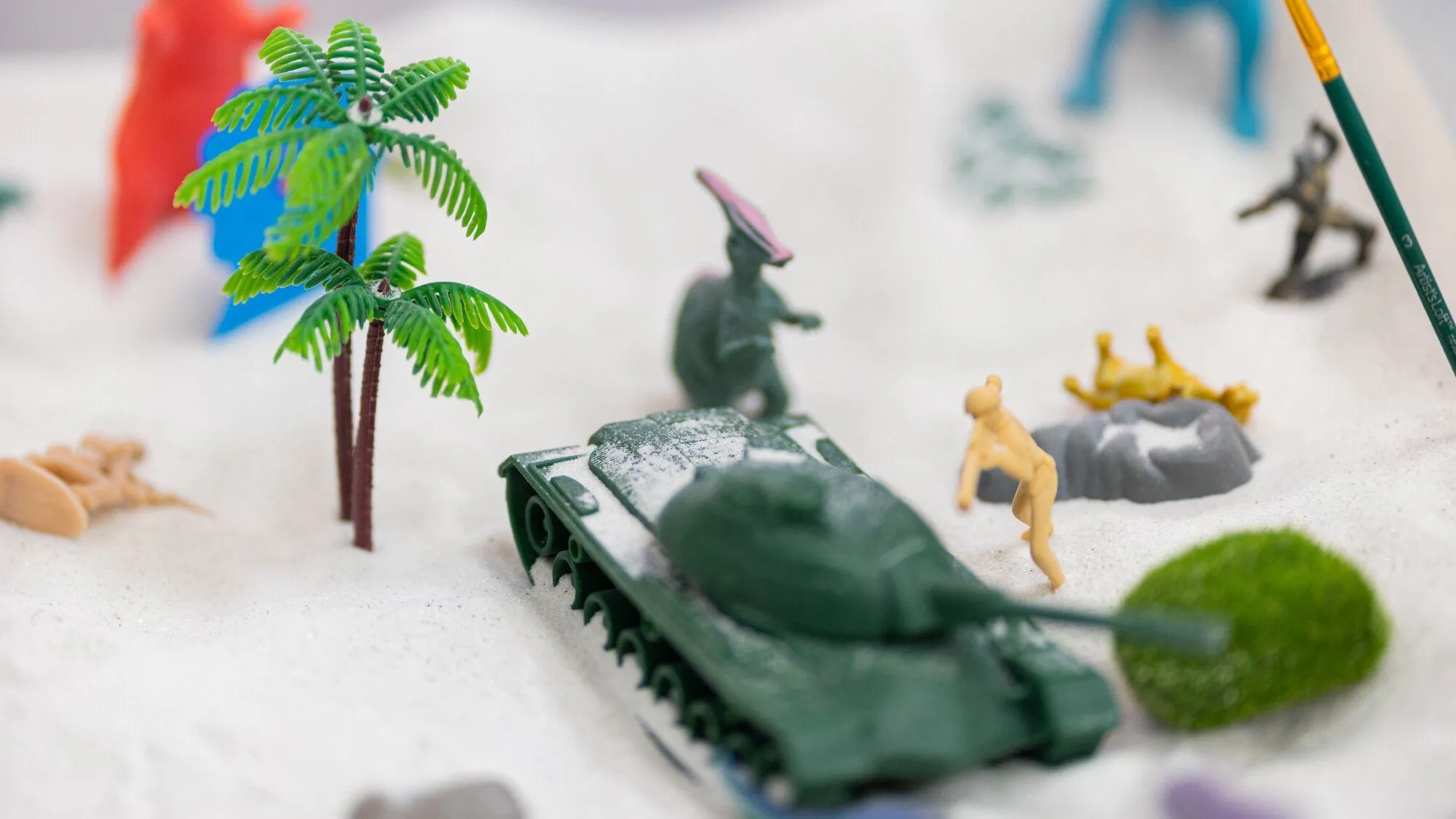 A sandtray therapy scene with miniature figures used in Susana Romero's play therapy with children in Visalia